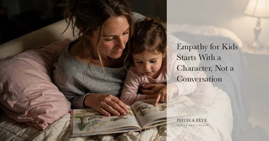 A mother and young daughter reading a picture book together on a bed, which is where empathy for kids actually begins