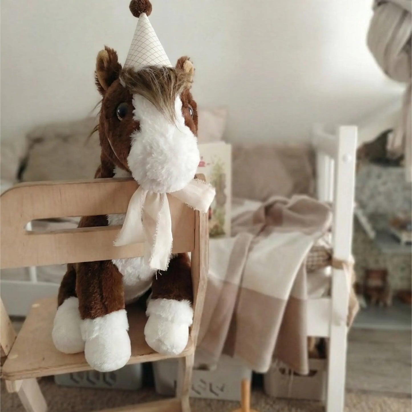 Lian the Pony plush toy sitting next to The Path That Held storybook and red envelope.