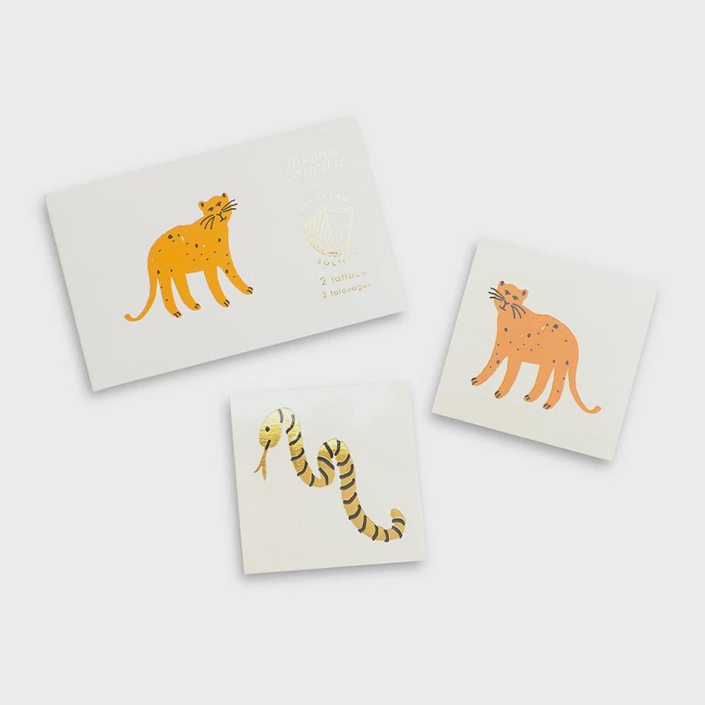 Safari-themed temporary tattoos featuring leopard and snake with gold foil