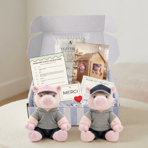 The Petal and Pip StoryTime ToolKit open in its gift box with both plush pigs, The Second House storybook, instructions, Plush Pal Promise certificate, eco fill and red plush heart
